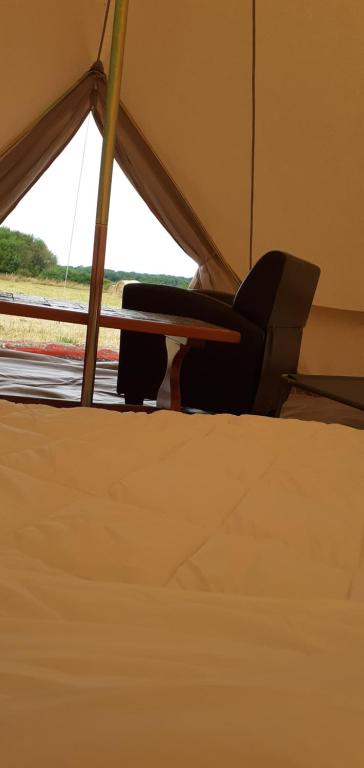 a close up of a bed in a tent at La tente saharienne du Perche .Chevaux. 