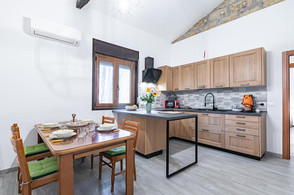a kitchen with a wooden table and a dining room at Teatro Massimo Central Elegant Apartment x5 in Palermo