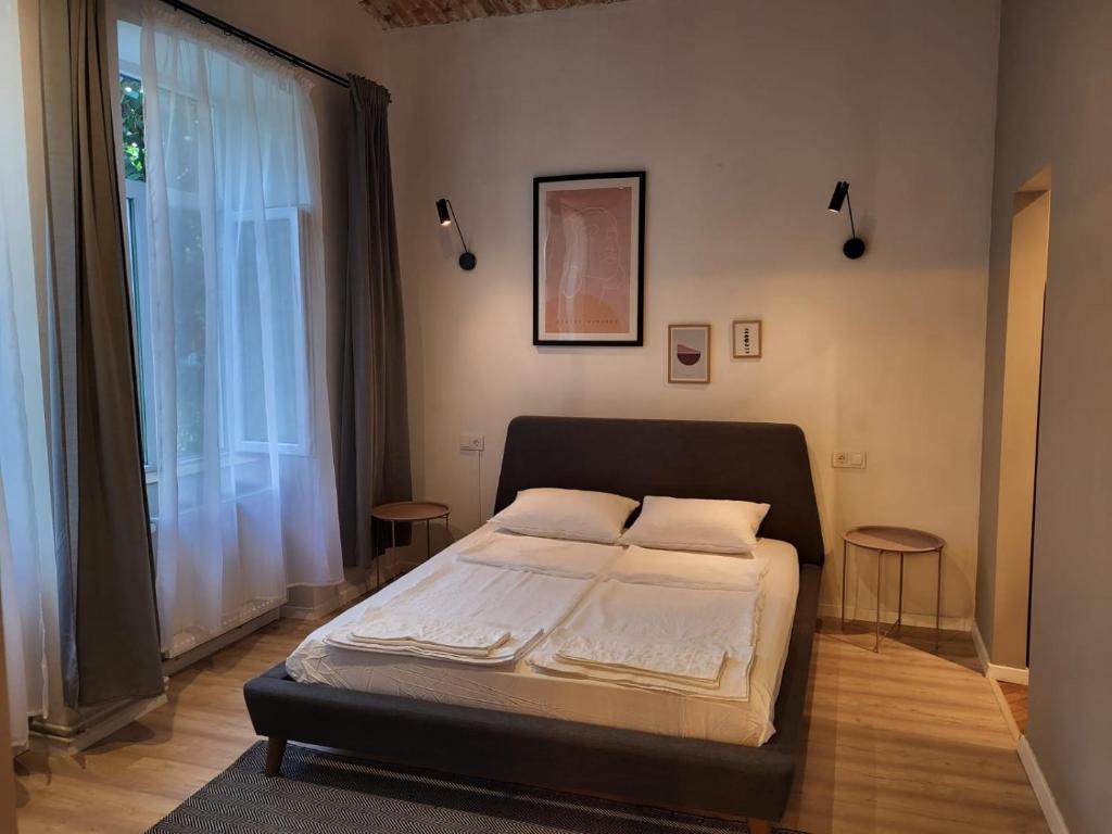 a bedroom with a bed and a large window at Quiet green oasis in city center in Cluj-Napoca