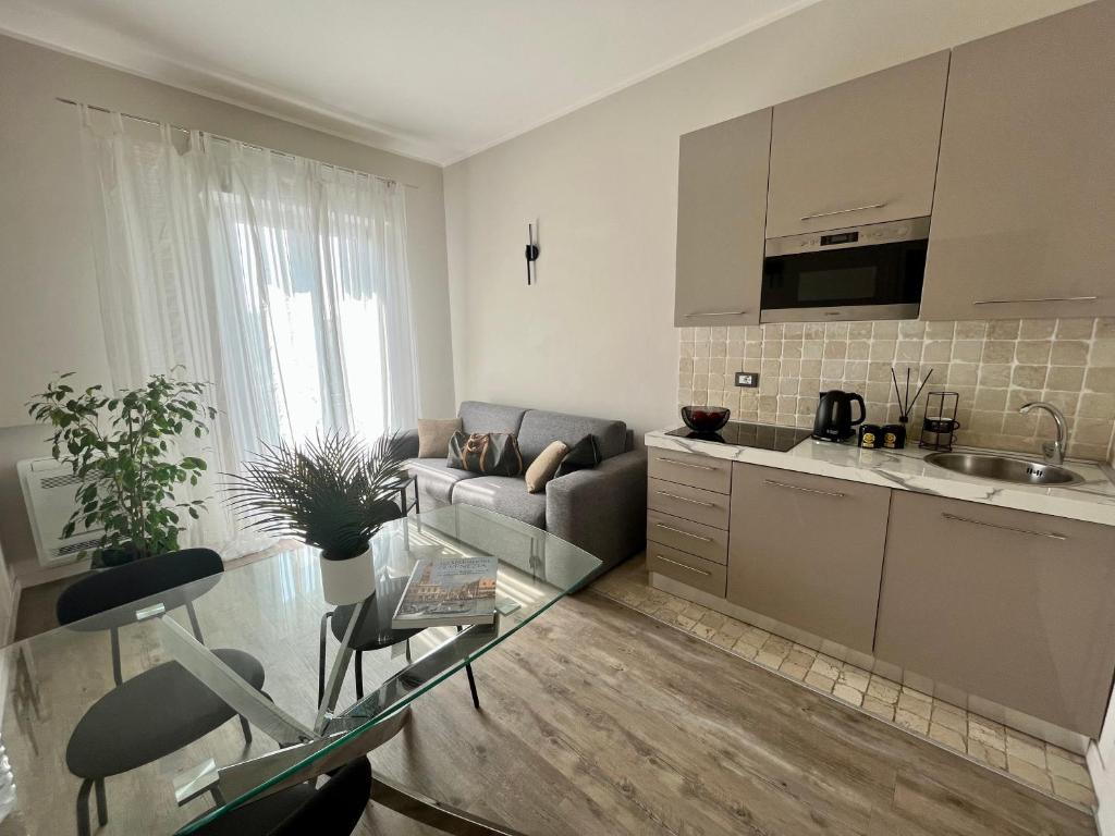 a kitchen and living room with a couch and a table at Garda Flow Holiday Home in Lonato del Garda