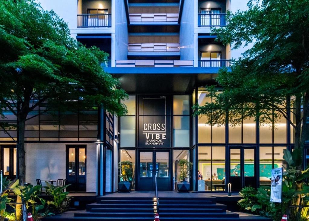 a building with a sign that reads guest virtue at Cross Vibe Bangkok Sukhumvit in Bangkok