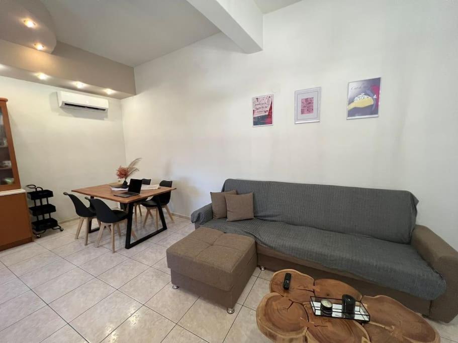 a living room with a couch and a table at Minimalist Flat with Balcony in Heraklio Town