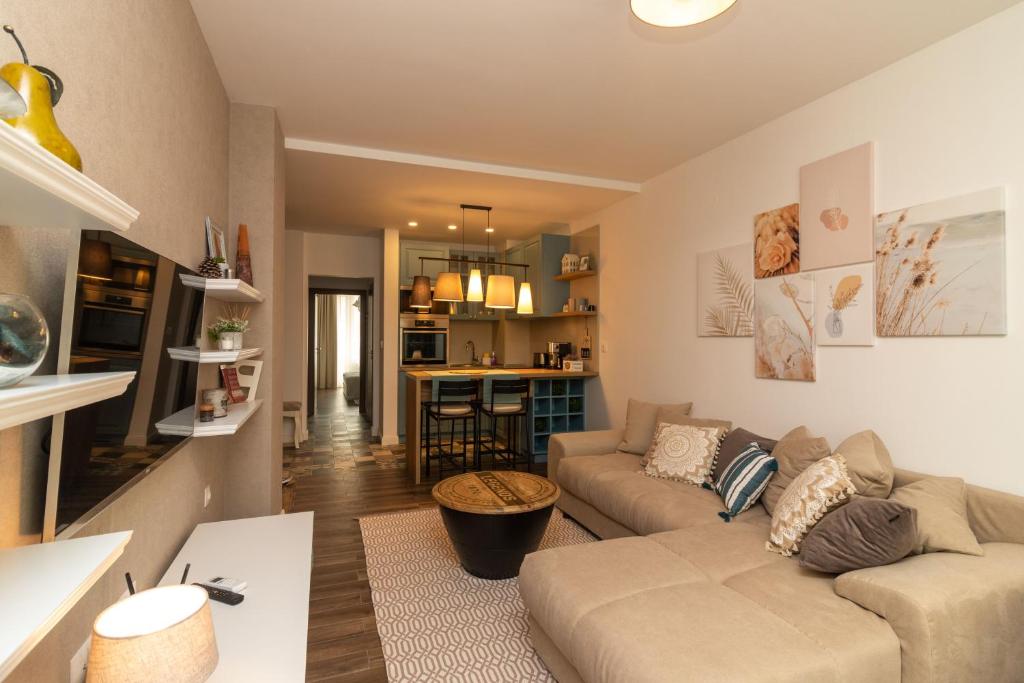 a living room with a couch and a table at Central Sofia Condo in Sofia