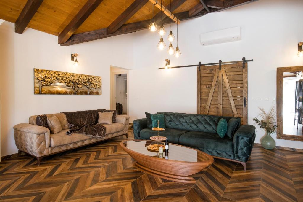 a living room with two couches and a table at Luxury Villa Nature with heated private pool, sauna & fire pit, a short walk to the beach in Milna