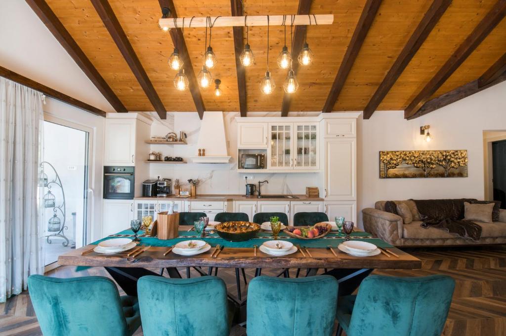 a kitchen and living room with a table and chairs at Luxury Villa Nature with heated private pool, sauna & fire pit, a short walk to the beach in Milna