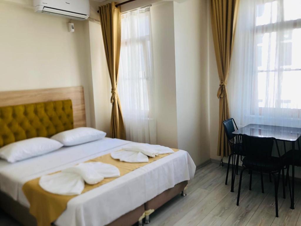 a bedroom with a bed and a table and a desk at Halil Bey Konağı in Istanbul