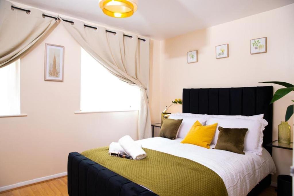 a bedroom with a large bed with yellow pillows at Inviting 1-Bed Apartment in London near Hotsput in London