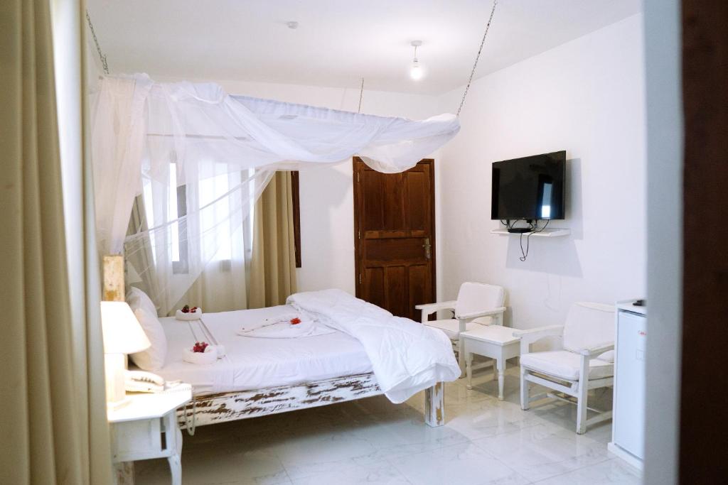 Postel nebo postele na pokoji v ubytování Met Beach Resort Malindi