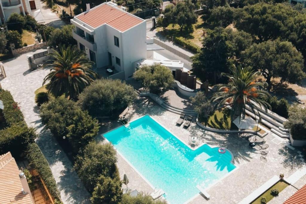 an aerial view of a swimming pool in a resort at Rio Deluxe Villa in Áyios Yeóryios