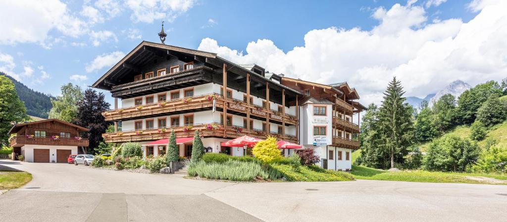 a large building in the middle of a road at Hotel Unser Unterberg in Maria Alm am Steinernen Meer