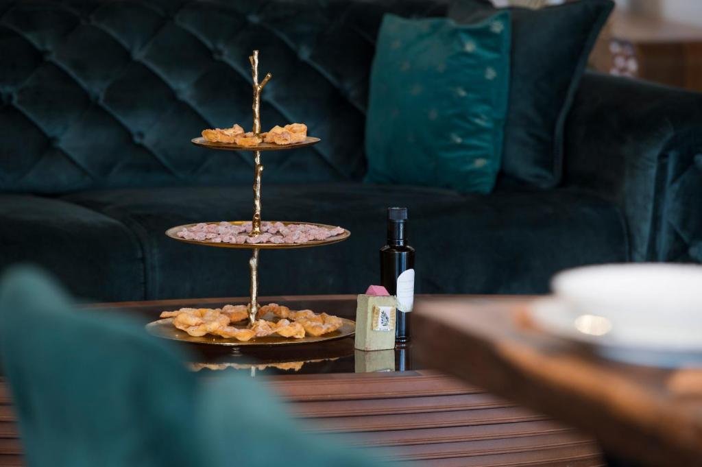 a table with two plates of food and a bottle of wine at Luxury Villa Nature with heated private pool, sauna & fire pit, a short walk to the beach in Milna
