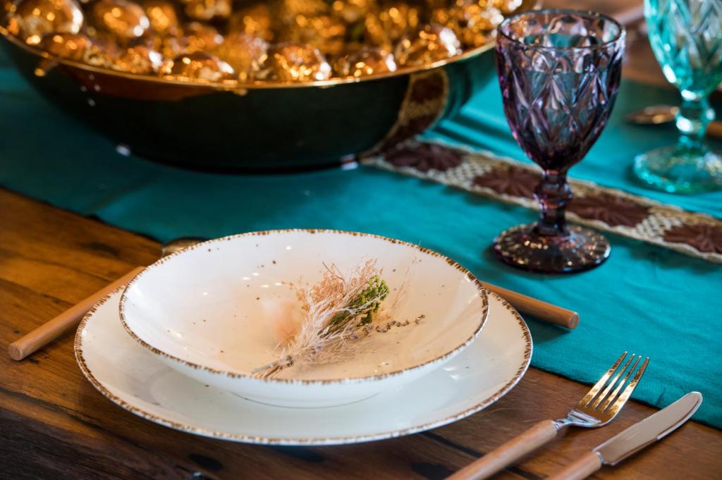 a plate of food on a table with a bowl of food at Luxury Villa Nature with heated private pool, sauna & fire pit, a short walk to the beach in Milna