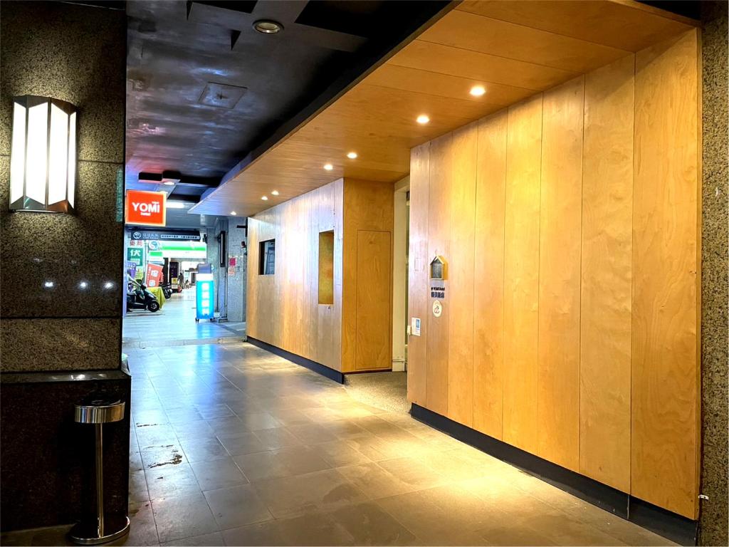a hallway of a building with wooden walls at Yomi Hotel - ShuangLian MRT in Taipei