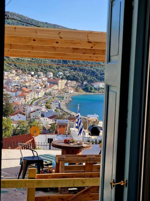 a balcony with a table and a view of a city at Neoclassical Samos House Nafsika in Samos