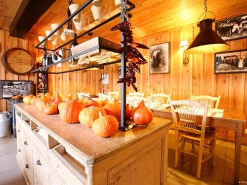 a table with pumpkins on it in a room at Hôtel Le Résinier in Le Barp