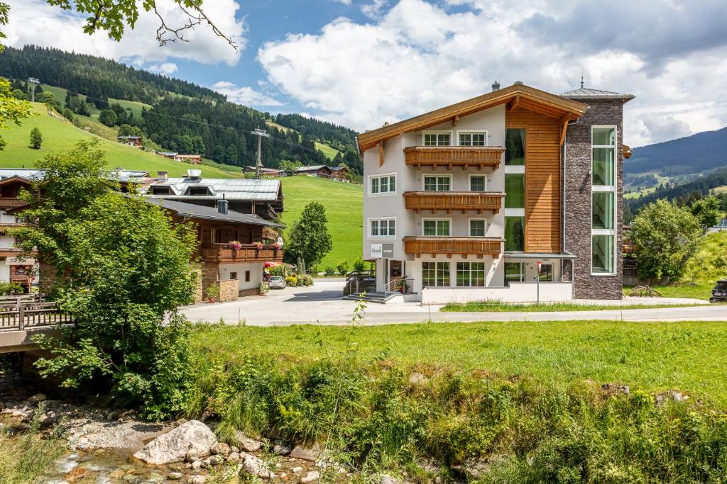 a large building in the middle of a village at Appartements Ferienwohnungen Unser Unterberg in Maria Alm am Steinernen Meer