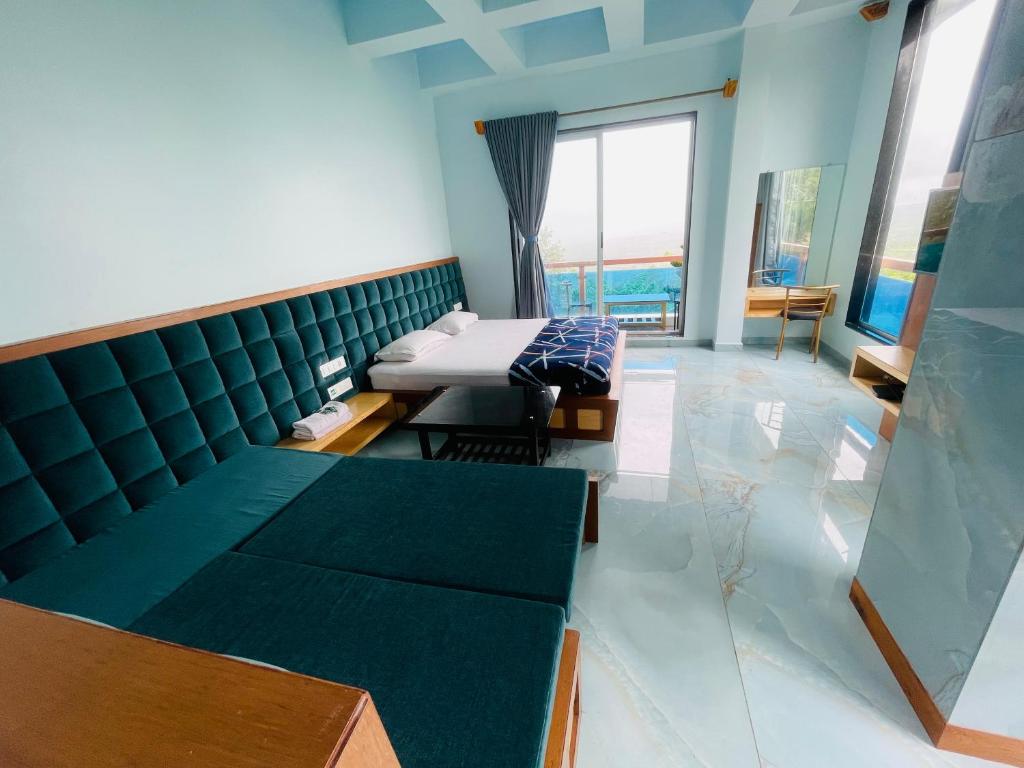 a hospital room with a couch and a bed at hotel saptarang residency panhala in Panhāla