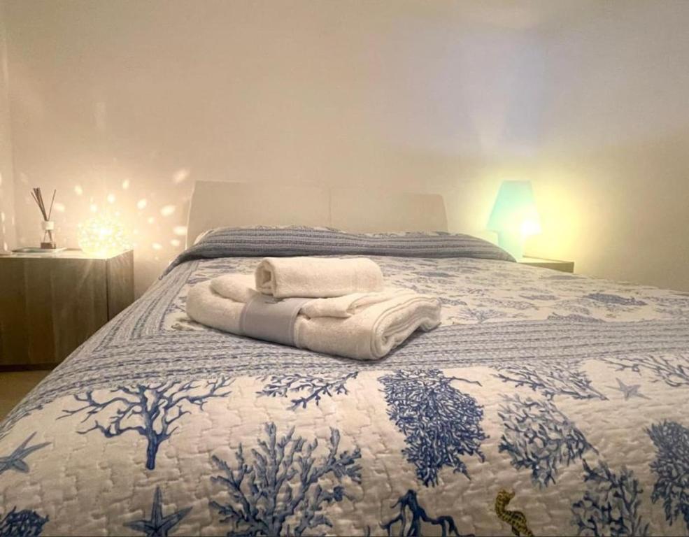a bedroom with a bed with towels on it at Dimora Favale Guglielmi in Polignano a Mare