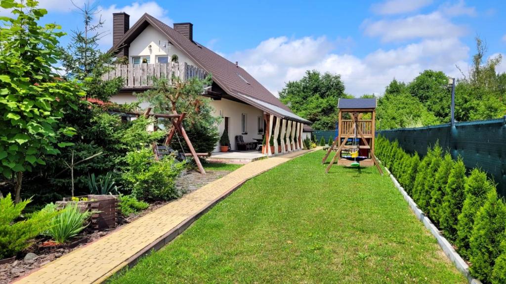 a garden with a house and a playground at Agroturystyka Kasprzykówka 