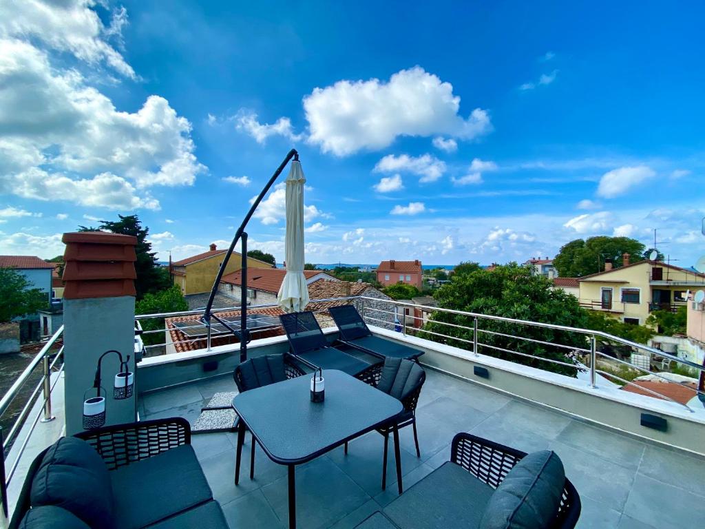 a patio with a table and chairs on a balcony at Apartment MM22 in Peroj