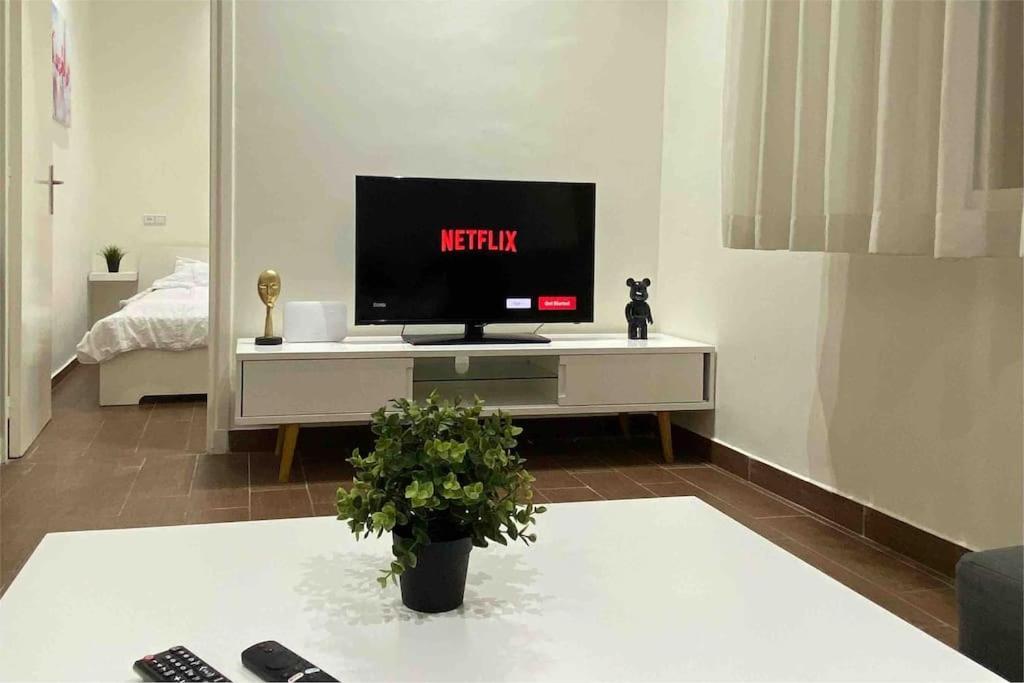 a living room with a television on a table at Joli Studio au Centre Ville avec WIFI - Netflix in Casablanca