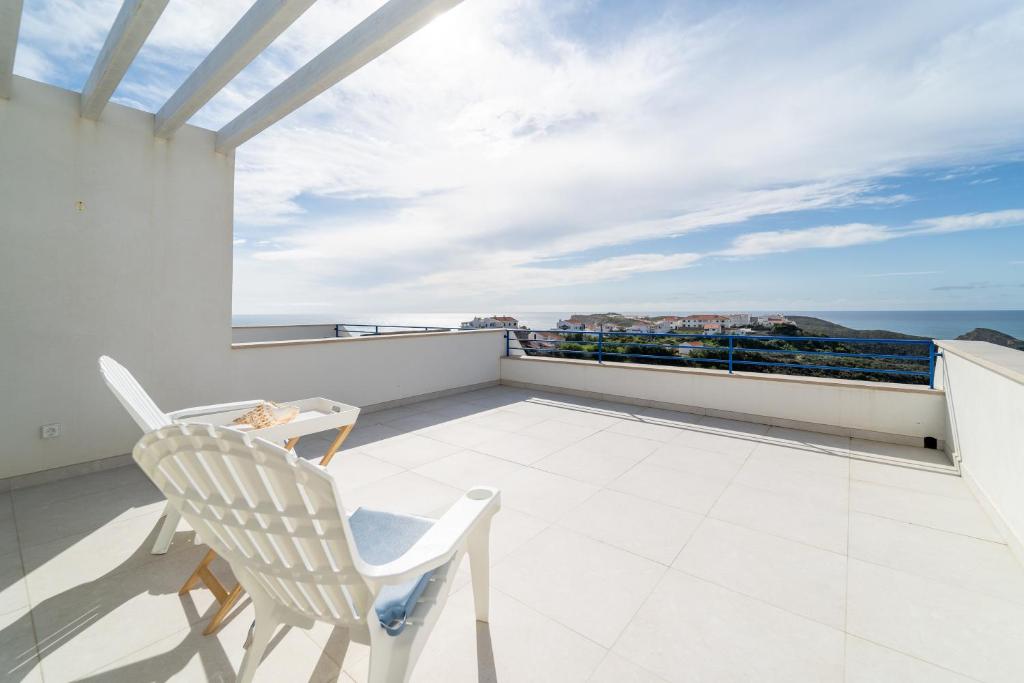 d'un balcon avec une chaise et une vue sur l'océan. dans l'établissement Vale Terra Mar, à Aljezur