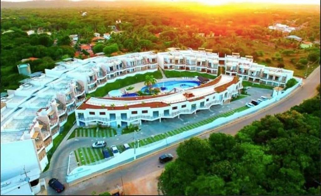 an aerial view of a large building with a pool at Pipa Brisas do Amor in Pipa