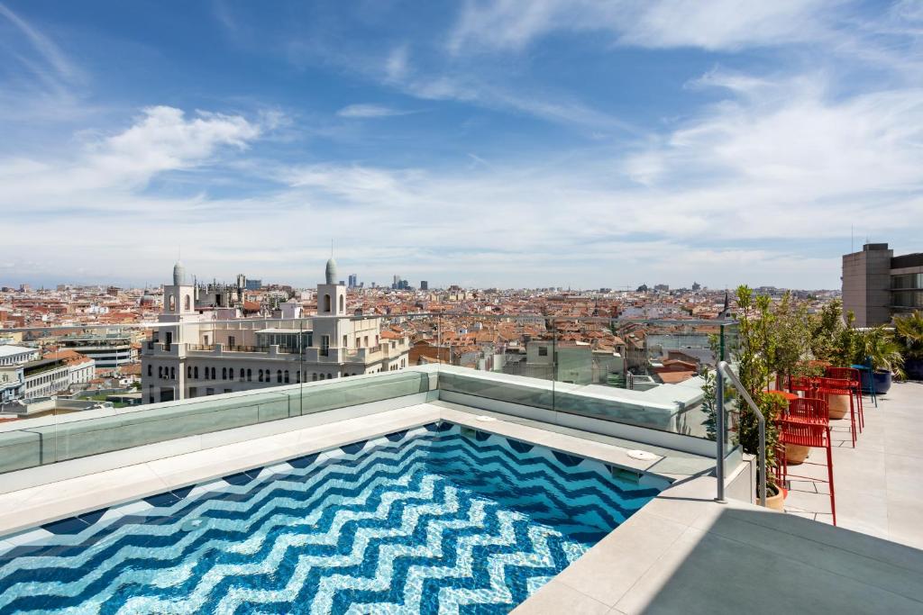 a swimming pool on the roof of a building at Room Mate Macarena, Madrid Gran Vía in Madrid