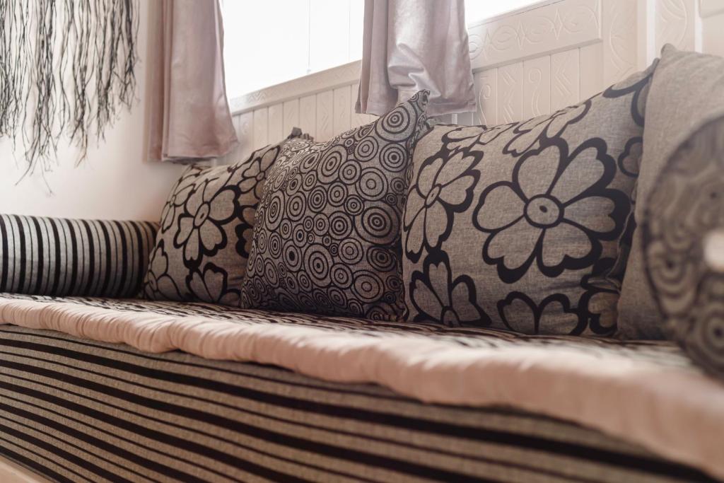 a couch with pillows on it in a room at The Rina Hostel in Agadir