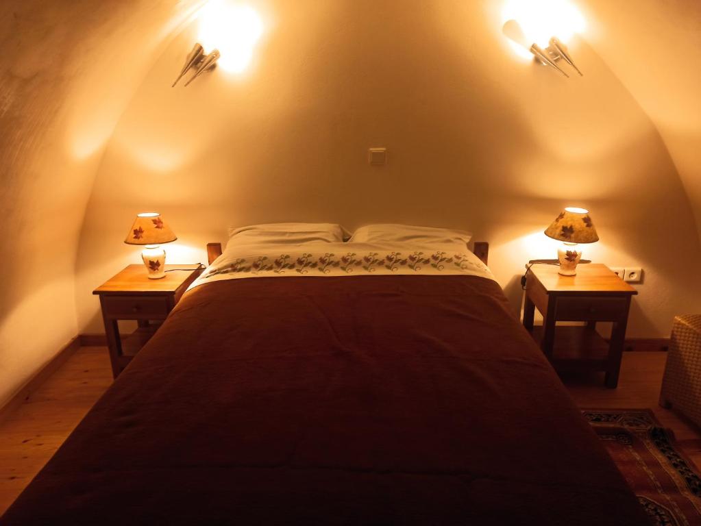Bett in einem Zimmer mit zwei Lampen an zwei Tischen in der Unterkunft Avgonima Family's Rooms in Chios
