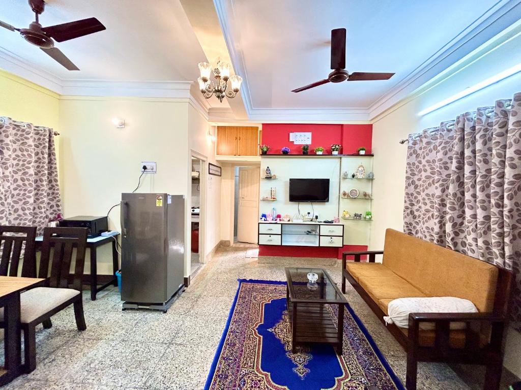 a living room with a couch and a tv at Classic 2BHK Serviced Apartment beside Jadavpur University in Kolkata