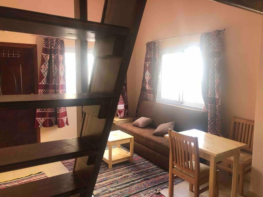 a living room with a bunk bed and a table at Dahab Relax Studio 2 in Dahab