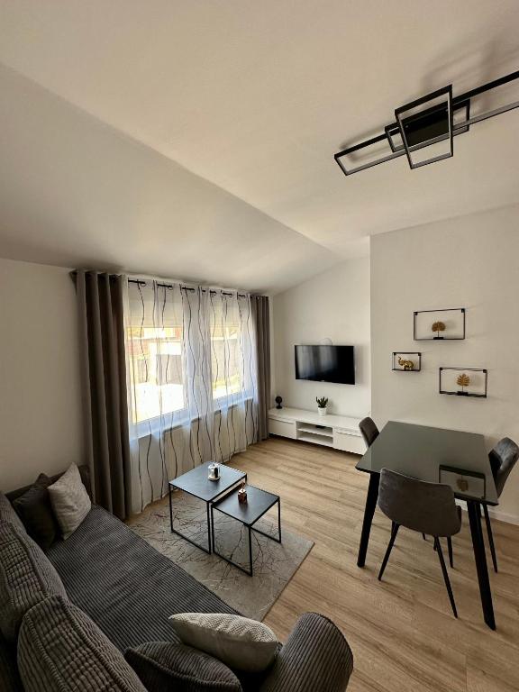 a living room with a couch and a table at Apartment Tiffany in Solin