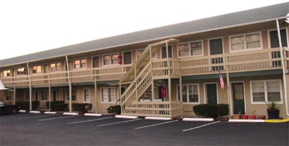 a large building with a staircase in a parking lot at Swiss Motel in Riverhead