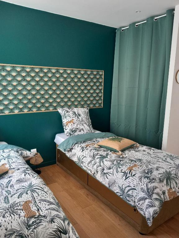 Postel nebo postele na pokoji v ubytování Les gîtes Ambleteuse