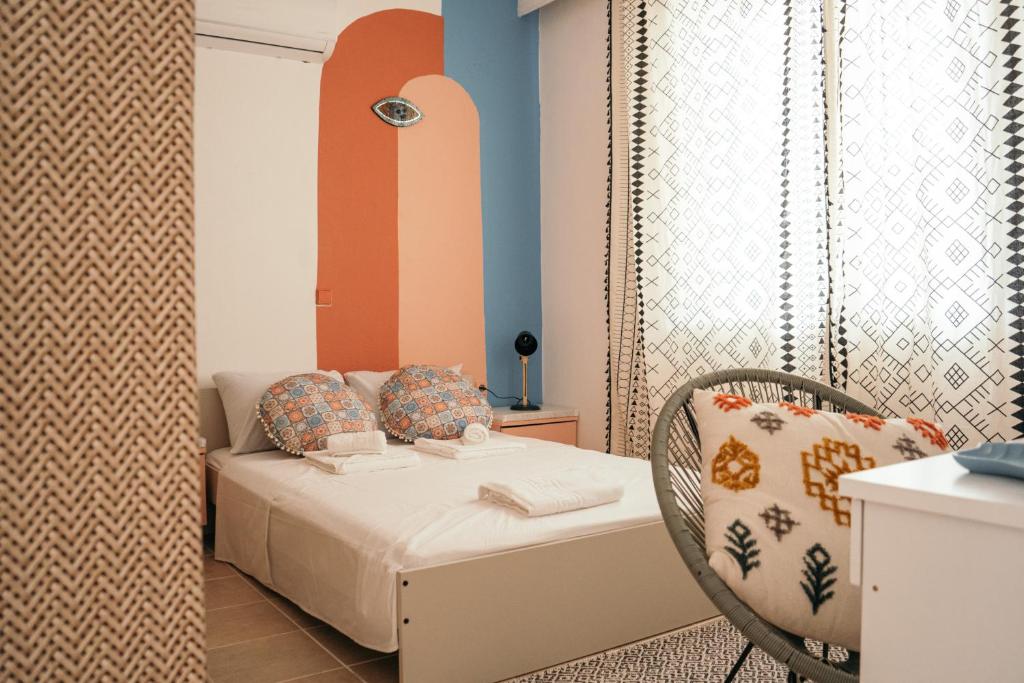 a small bedroom with a bed and a chair at Villager's Art Apartment in Paradeísion