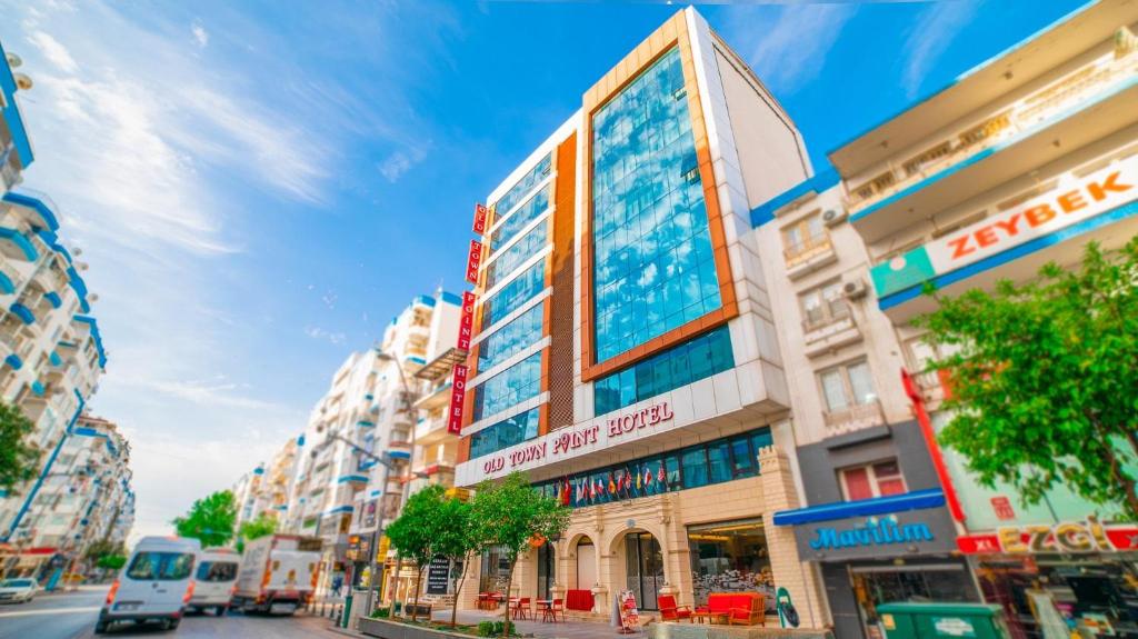 a building with a sign on it on a city street at Old Town Point Hotel & Spa Antalya in Antalya