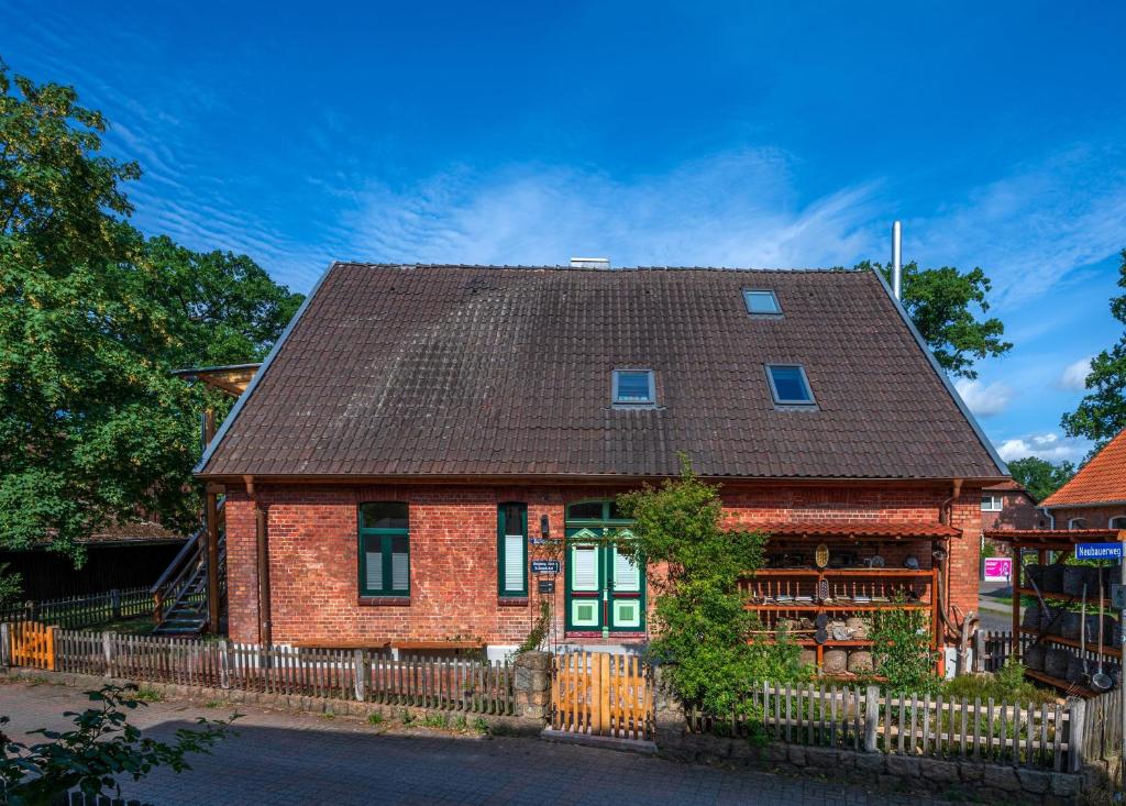 a red brick house with a brown roof at Ferienwohnung Schulstr 8 Müden in Müden