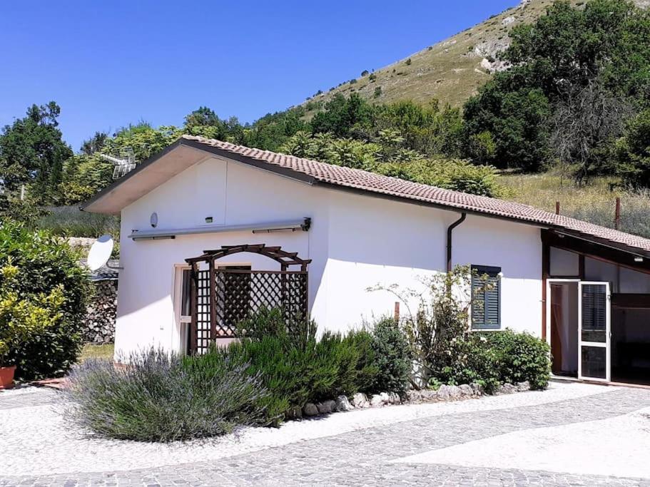 a small white building with a hill in the background at TorrediLuna - MoonTower 