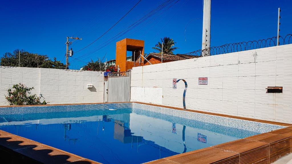 una piscina frente a una pared blanca en Casa na Praia do Piruí - Arembepe en Arembepe