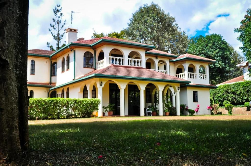 a large white house with a large yard at Nyari estate in Nairobi