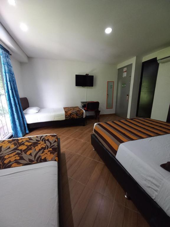 Postel nebo postele na pokoji v ubytování Hotel Quinta Avenida