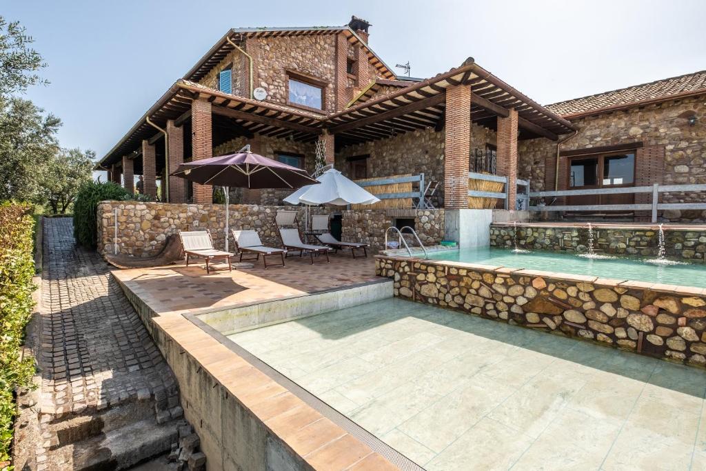 Canino的住宿－Casale di Primula Rossa，一座带游泳池的房子和一座带房子的房子