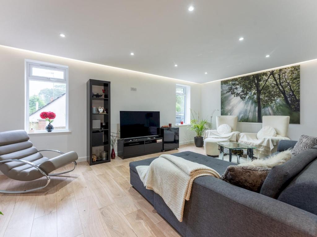 a living room with a couch and a tv at Pass the Keys Gorgeous Central House in Bournemouth