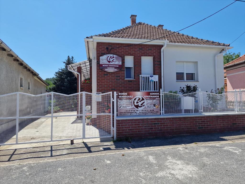 a building with a fence in front of it at Boros Vendégház in Bogács