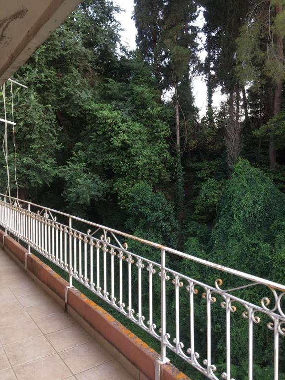 a white railing on a bridge with trees in the background at Dream house in Ágios Rókkos