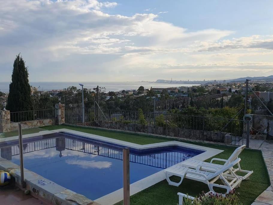 una casa con piscina y silla en Casa con gran jardín y unas preciosas vistas, en Teià