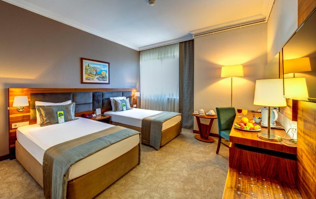 A bed or beds in a room at Bera Konya Hotel