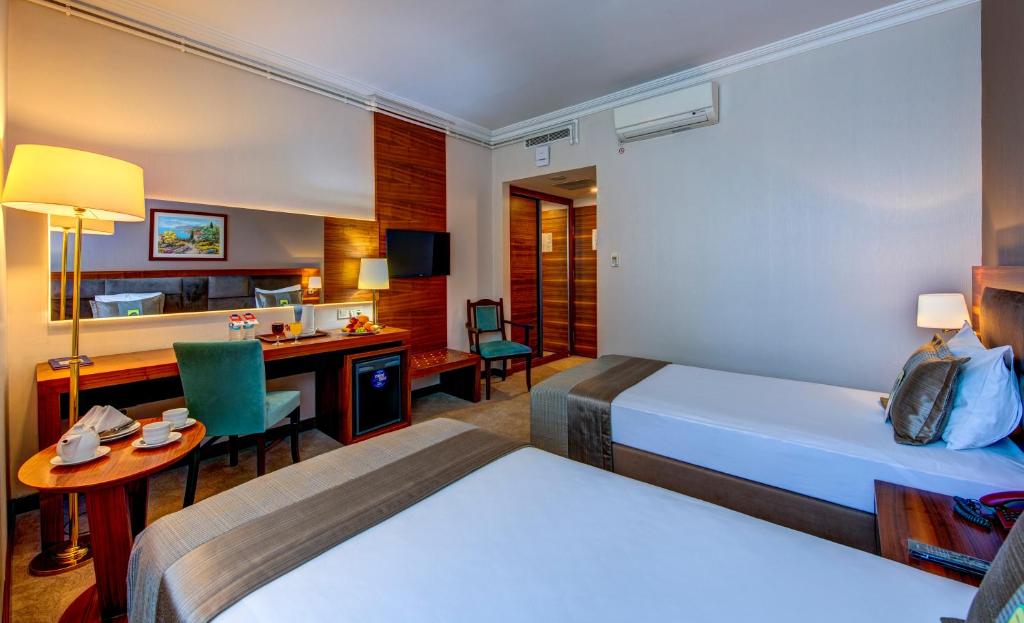 A bed or beds in a room at Bera Konya Hotel