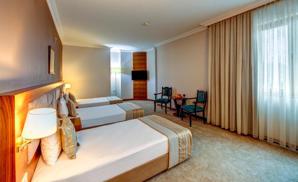 A bed or beds in a room at Bera Konya Hotel